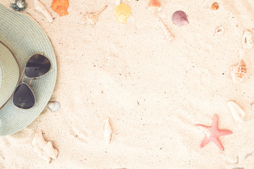 Summer background - vacation concept with straw hat and sunglasses on sandy tropical beach -...