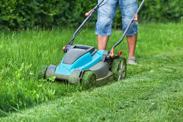 Man cutting the grass with a lawn mower