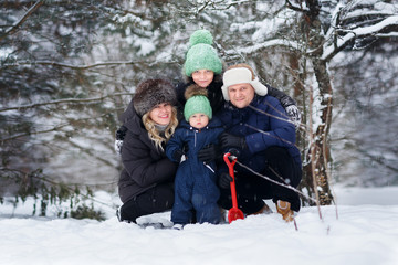 Fototapeta na wymiar Parents with two sons outdoor. Winter. .