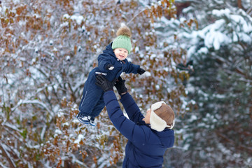 Fototapeta na wymiar Little boy with father outdoor. Winter.