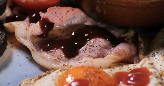 Dolly close up push in view of a full cooked English breakfast