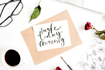 Inspirational quote "Make Today Amazing" written in calligraphic style on paper with red roses, laptop, coffee on white background. Flat lay, top view