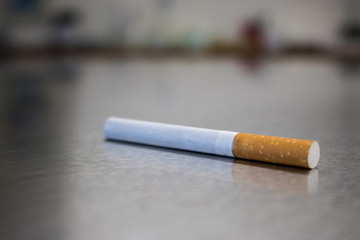 Isolated Cigarette on silver metal ground