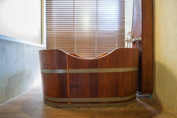 A wooden bathtub in a bathroom, interior decoration concept