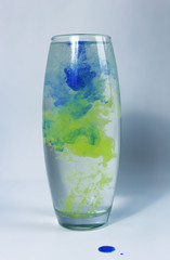 paint in the water. Watercolor paint in a vase