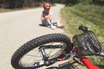 Boy is lying hurt after a bicycle accident. Kids safety concept