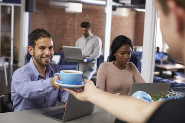 Businesspeople Working On Laptops In Office Coffee Bar