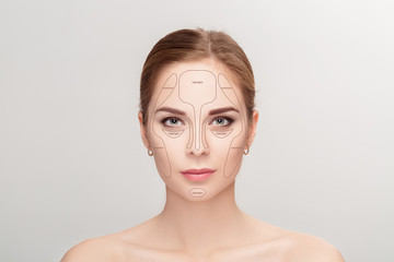 Contouring. Make up woman face on grey background.  Professional