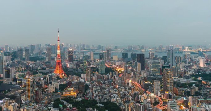 Time-lapse of Skyline with the Tokyo tower at sunset. Tokyo tower is a communications and observation tower located in the Shiba-koen district