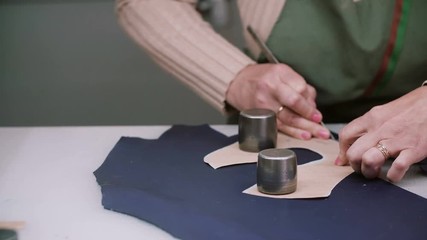 Shoemaker master cutting shoe leather as template, clicking the upper. Footwear manufactory. Close-up, slider left, 4K