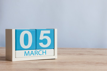 March 5th. Day 5 of month, wooden color calendar on table background. Spring time, empty space for...