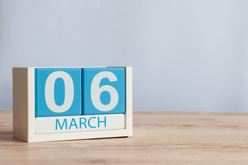 March 6th. Day 6 of month, wooden color calendar on table background. Spring time, empty space for...