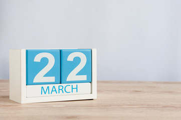 March 22nd. Day 22 of month, wooden color calendar on table background. Spring time, empty space for text