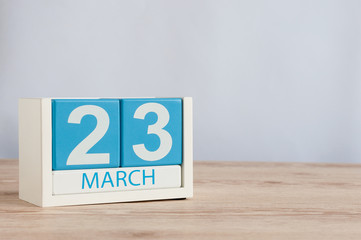 March 23rd. Day 23 of month, wooden color calendar on table background. Spring time, empty space for text