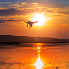 Fototapeta na wymiar drone at sunset. professional photo and 4k video processing. new innovations technology concept