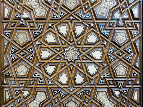 Closeup of arabesque ornaments of an old an aged decorated wooden door, Old Cairo, Egypt