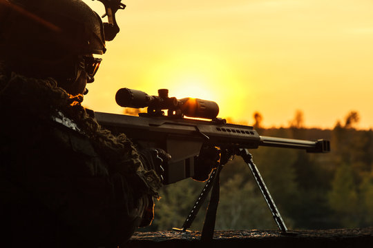 Army sniper with large-caliber sniper rifle seeking killing enemy. Silhouette on sky background. National security ensured, servicemen on guard