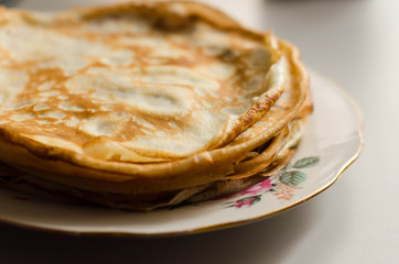 Pancakes or Russian Blintzes on white background. Selective focus.