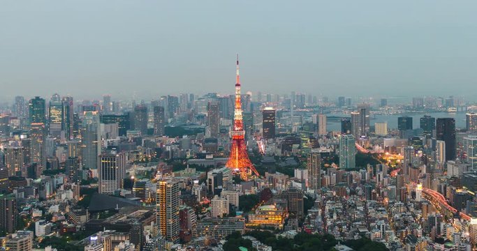 Time-lapse of Skyline with the Tokyo tower at sunset. Tokyo tower is a communications and observation tower located in the Shiba-koen district