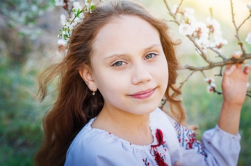 The girl child  in the spring garden.