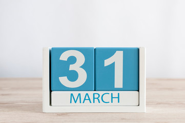 March 31st. Day 31 of month, daily calendar on wooden table background. Spring time, empty space...