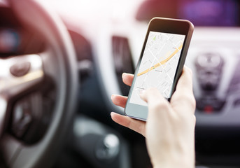 Female using navigation app on smart phone.
