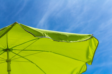 summer background green parasol with blue sky background