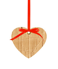 cardboard heart with red ribbon bow isolated on white