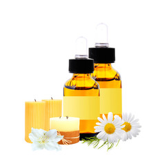 bottles with essence oil, candles and chamomiles