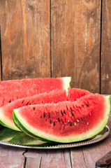 Slices of watermelon on a wooden background