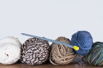 Close Up Of Threads For Knitting And Spokes On On Wooden Table On White Background Copyspace.