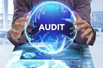 Business, Technology, Internet and network concept. Young businessman shows the word on the virtual display of the future: Audit