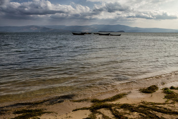 Wooden fishing boats in the drift. The Lake Baikal. Chivyrkuisky Bay. Buryatia. Russia.