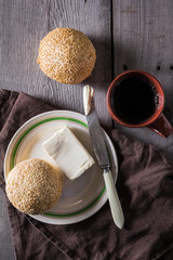 Fresh bun with butter and coffee for breakfast