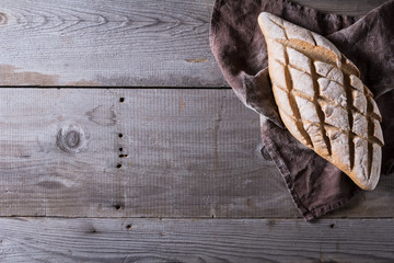 Freshly baked traditional bread on wooden table