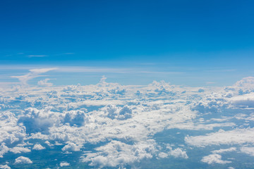 Fototapeta na wymiar Aerial view of clouds and blue sky through airplane window, blue sky with cloud, many cloud in blue sky