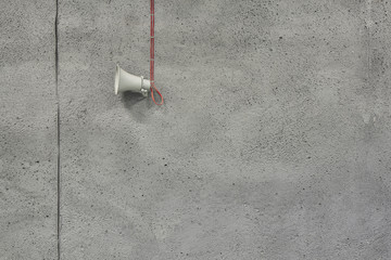 Megaphone on the concrete wall background in underground garage.