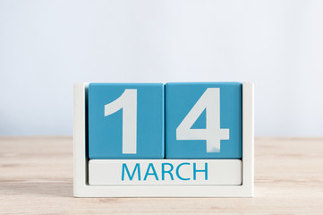 March 14th. Day 14 of month, daily calendar on wooden table background. Spring time. Commonwealth...