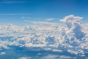 Aerial view of clouds and blue sky through airplane window, blue sky with cloud, many cloud in blue sky