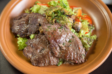 Sliced roasted veal and vegetable salad, top view