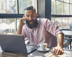 Man in cafe in front of computer