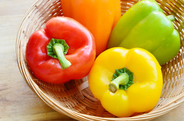 variety of colorful Bell pepper or sweet pepper.
a lot of Capcicum in basket on wooden 
background.