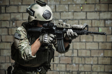 US Army Ranger aiming rifle with two hands. Shooting stance and grip