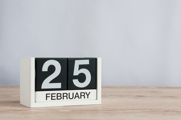February 25th. Day 25 of month, daily calendar on wooden table background. Winter concept. Empty space for text