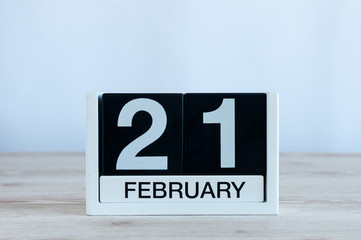 February 21st. Day 21 of month, black and white calendar on wooden table background. Winter time. Empty space for text