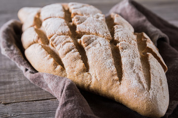 Freshly baked traditional bread on wooden table