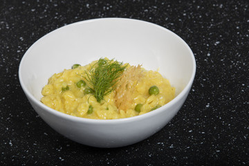 risotto with beans and saffron on white plate