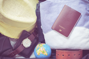 Outfit of traveler on green background with copy space, Travel concept,Travel accessories for trip,Travel accessories costumes. Passports, luggage, The cost of travel maps prepared for the trip