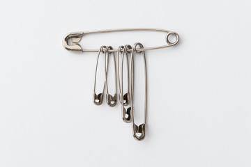 Set of safety pins / Set of safety pins of different sizes on white background