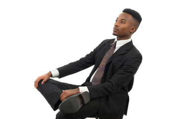 businessman seated on a chair wearing suit and tie